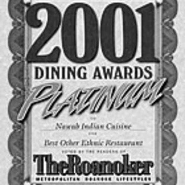 A black and white award certificate from 2001, recognizing Nawab Indian Cuisine for dining excellence.